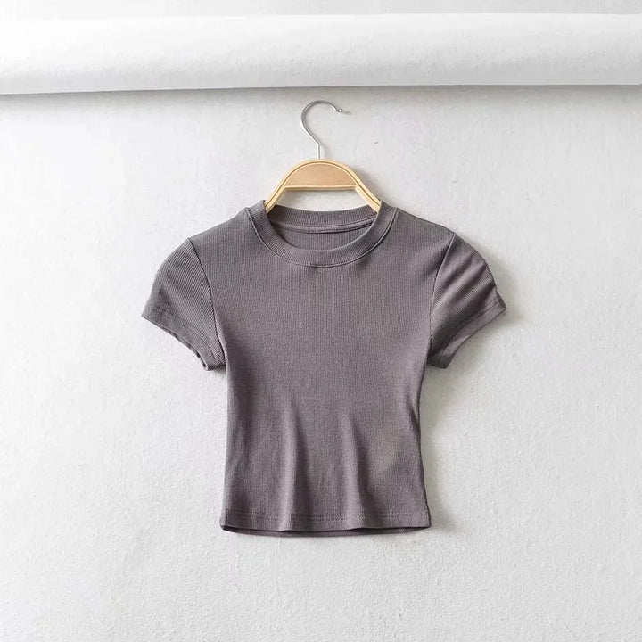 Turn Up the Heat in Style
This slim-fit, stretchy crop top features a sexy O-neck and short sleeves — perfect for summer days and night-outs. Soft, flattering, and made to hug your curves. ☀️👚